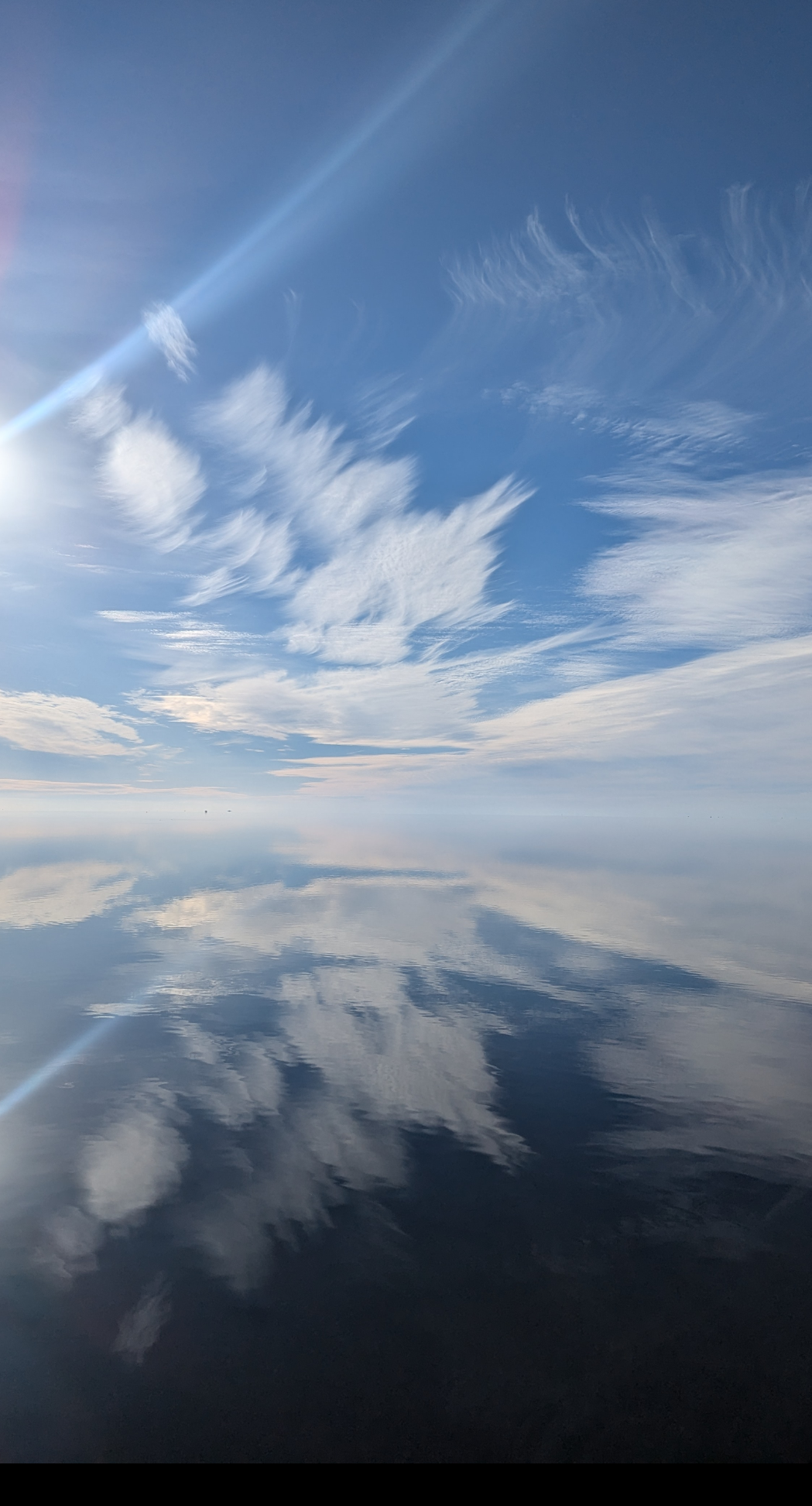 white clouds reflecting off of the Pamlico Sound on a calm day
